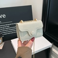 Mint green suede crossbody bag with white stitching and gold chain strap detail - White