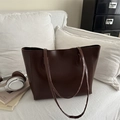 Minimalist large dark brown matte leather tote bag with shoulder strap in a home setting - Dark Brown