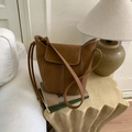 Detail view of brown vintage bucket bag with contrast stitching on a stylish table - No Pendant / Brown