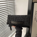 Chic black leopard print clutch bag with golden metallic studs on leather hand strap - Black