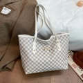 Retro cream tote bag with grey M letter patterns and gold bow detail on a casual background - White