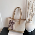 Chic canvas tote bag with leather trim and decorative silk scarf on a white display - Khaki