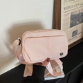 Light pink nylon crossbody bag with adjustable strap and metallic logo for casual travel - Pink