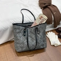 Quilted large capacity grey tote bag with camouflage texture and black handles on wood floor - Gray