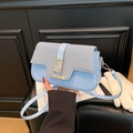 Light blue crossbody bag with woven texture lid and golden geometric buckle clasp - Blue
