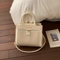 Detail of a cream handbag featuring beige woven texture and metallic gold zippers - No Pendant / White