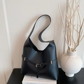 Matte black leather tote bag with minimalist strap buckle and spacious hobo silhouette - Black