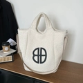 Chic beige plush tote bag with black circular logo and detachable shoulder strap - Beige