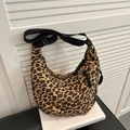 Leopard print canvas dumpling bag with adjustable black shoulder strap and crescent shape - Leopard Print