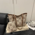 Canvas tote bag set with brown M monogram pattern and leather handles on plush background - Khaki