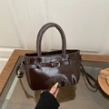Dark brown glossy patent leather handbag with adjustable strap and top handle design - Brown