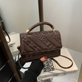 Dark brown patent leather handbag with embossed fashion lettering and a glossy finish - Brown