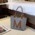 Grey textured tote bag with brown leather M patch and long shoulder straps - Gray