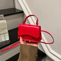 Red mini crossbody bag with wavy flap design and slim shoulder strap for women - Red