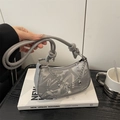 Gray shoulder bag with graffiti pattern, star charms, and elegant knotted strap detail - Silver