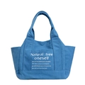 Dark blue canvas tote bag with white minimalist typography print on plain white background - Blue