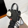Black matte leather crossbody bag with wave design and plush cloud charm accessory - Black