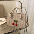 Cream woven cherry crossbody bag with leather handles and adjustable shoulder strap - Off White