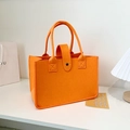 Vibrant orange felt tote bag with metal snap closure and reinforced stitching - Orange
