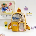 Mochila infantil amarilla y beige con oso de peluche 3D y bolsillo frontal de PVC transparente - Amarillo