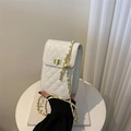 Detail of white quilted crossbody phone bag with gold metal clasp and chain strap - White