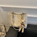 Detail of off-white PU tote bag with FASHION embossing and a cute knitted bear charm - White Without Pendant