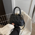 Chic black shell-shaped crossbody bag with geometric quilting and golden metal zippers - Black