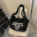 Large black canvas shoulder bag with white letter print and wide strap in retro style - Black
