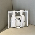 Frosted translucent PVC tote bag with letters and matching inner pouch on grey background - White