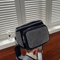 Detail of black rhinestone bucket bag with silver zipper pockets and herringbone strap - Silver Black