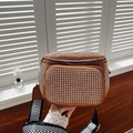 Detail of a brown suede rhinestone bucket bag featuring a woven herringbone shoulder strap - Yellow Brown