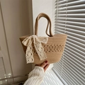 Fashionable woven straw handbag with a white lace bow accessory and spiral rope pattern - Khaki