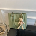 Green faux leather tote bag with gold chain strap and bear pendant on white background - Bear Pattern Green