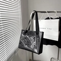 Women's tote bag featuring bold black and white liquid sand wave patterns on smooth fabric - Black