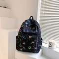 Detail view of black backpack with rainbow laser letter printing and side pockets - Black
