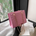 Pink quilted PU leather crossbody bag with elegant gold chain strap and wavy stitching - Pink
