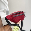 Detail of burgundy corduroy waist bag showing dual zipper pockets and adjustable nylon strap - Burgundy