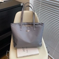 Minimalist grey large capacity tote bag with metal plaque on a chair - Gray