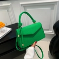 Minimalist green woven leather crossbody bag with cylindrical top handle and knot detail - Green