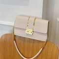 Chic cream crocodile pattern crossbody bag with gold chain strap on a wooden chair - White