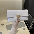 Detail of white crocodile pattern envelope clutch with gold H-shaped metal buckle - White