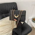 Chic black quilted crossbody bag with gold crescent moon buckle and chain strap - Black