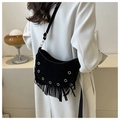 Detail of black crescent suede crossbody bag with long tassels and gold metal eyelets - Black