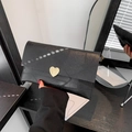Fashionable black envelope clutch with cracked leather texture and golden heart clasp - Black