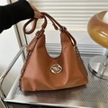 Caramel brown leather tote bag with metal chain strap and round logo in a casual style - Brown