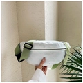 Detail of white woven crossbody bag showing textured diamond pattern and olive green strap - Green
