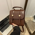 Vintage dark brown faux leather backpack with gold metal buckles and flap closure - Brown