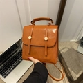 Vintage brown PU leather backpack and crossbody bag with metal buckle closure - Caramel color