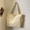 Cream canvas tote bag with multi-pocket design and metallic button detail on front - Off White
