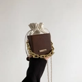 Brown leather drawstring bucket bag with thick gold chain handle and crossbody strap - Coffee